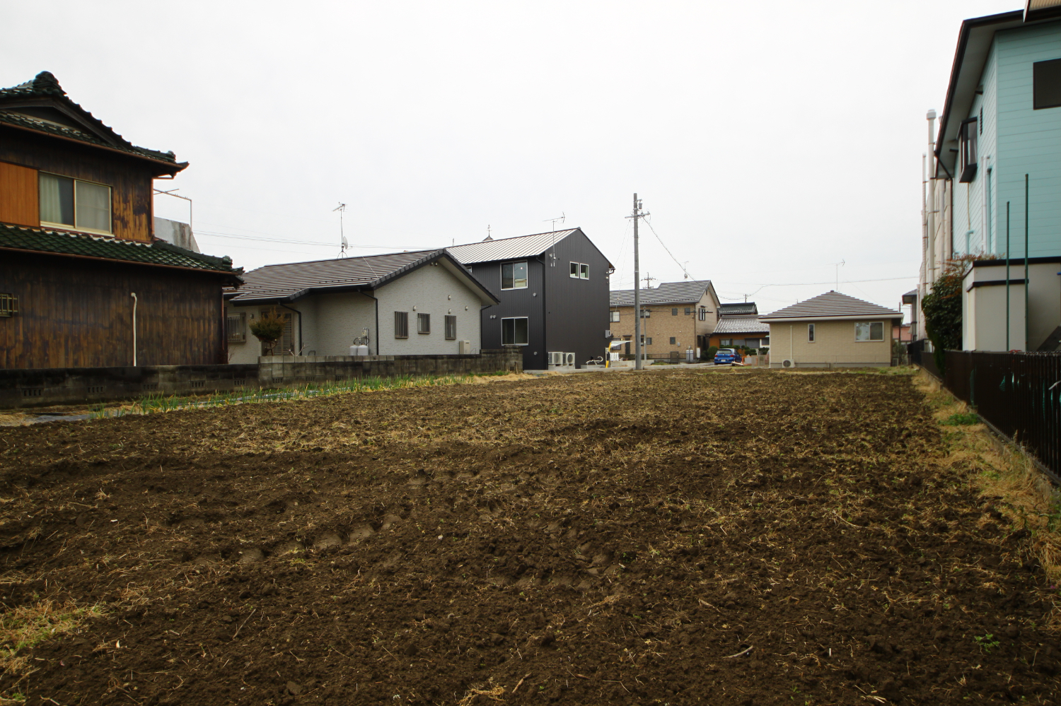 北側の隣地から建物の外観を撮影した風景。